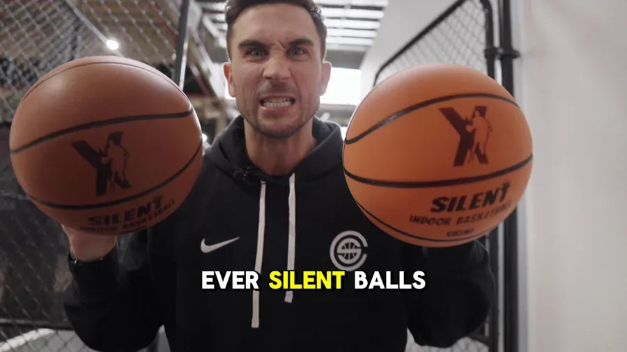 Jordan Lawley holding two YGA Silent Basketballs up to the camera