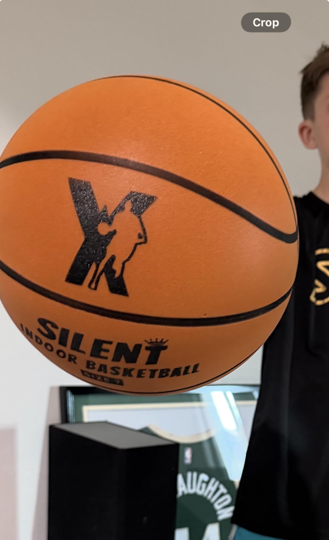 Kid holding the YGA Silent Basketball