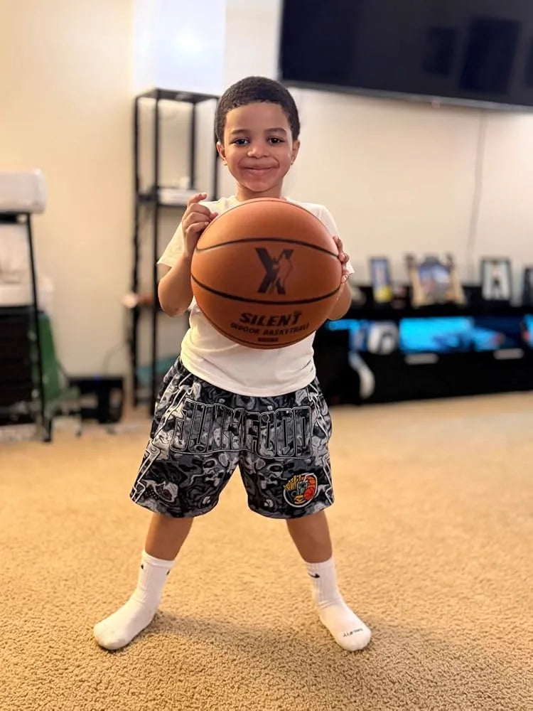 Young customer showing off his YGA Silent Basketball at home